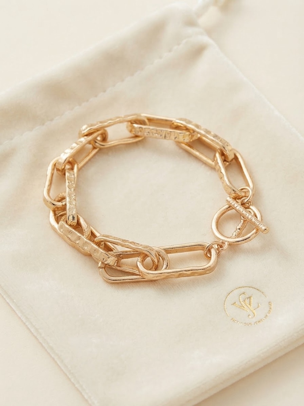 Gold-tone textured chunky link toggle bracelet.